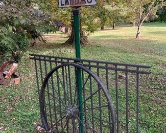 1930's street sign, wrought iron fence, wagon wheel