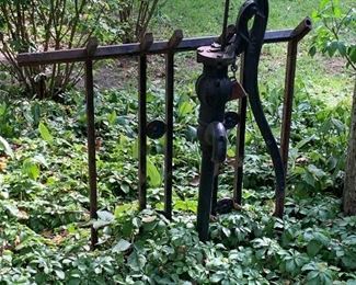 Well pump, wrought iron fence 