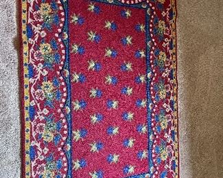 Item 29.                                                                                                   Red, yellow and blue rug.                                                                
64" length x 42" width
$30