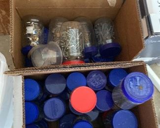 Two boxes of jars filled with nails and screws
