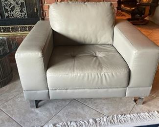 comfy gray leather arm chair with polished chrome legs.