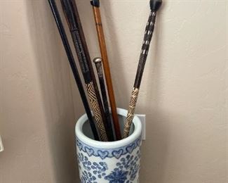 umbrella stand with canes and walking sticks.