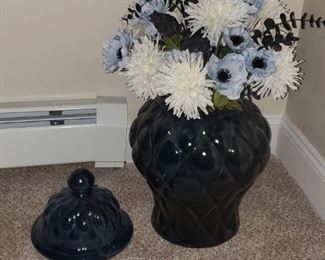 Silk flowers in large ceramic decorative vase.