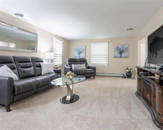 Glass contemporary table with end table and sofa table (shown in other pictures). Lamps, paintings and flowers.