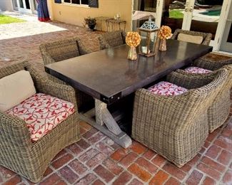Fabulous outdoor slate top trestle table, with 6 woven patio chairs....from Restoration Hardware!