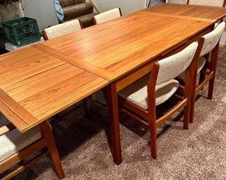 Beautiful Danish Modern Teak Table with Leaves on each end by Mobler Made in Denmark with 6 Upholstered Teak Chairs.
