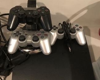 Play Station 3 (PS3) w/ 3 controllers, 20 games to choose from and a 2 controller recharge station.