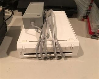 Nintendo Wii entertainment console. 2 available controllers w/ 10 games and a controller charge station to accompany it.