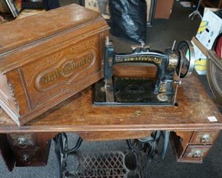 Vintage treadle sewing machine with contents in drawers.