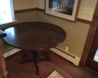 Butterfly detailed solid wood top with wrought iron base and two leafs.