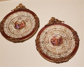 Pair of porcelain cabinet plates with brass trim