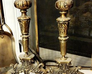Ornate brass andirons