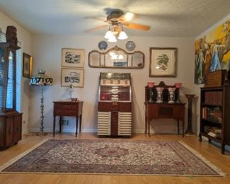 Vintage AMI, D-80 "700" jukebox, vintage fine Pakistan Persian Kashan design rug, 1880's two-drawer table, w/turned legs, vintage lighted curio cabinet, 3-D stained glass floor lamp, antique wood/black marble dry sink, framed pair of MCM originals, by listed industrial designer artist George Henry Kress (NYC), Victorian triptych wall mirror, pair of English porcelain blue/white plates, Vintage bookshelf filled with interesting old books, pair of vintage Bohemian glass lusters, vintage pair of  brass/marble table lamps, w/frosted rose glass shades and large (7' x 42") original oil on panel, by Meredith Pardue, entitled "Aurora" after Guido Reni.
