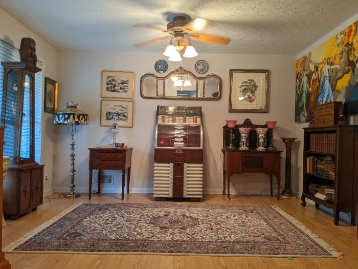 Vintage AMI, D-80 "700" jukebox, vintage fine Pakistan Persian Kashan design rug, 1880's two-drawer table, w/turned legs, vintage lighted curio cabinet, 3-D stained glass floor lamp, antique wood/black marble dry sink, framed pair of MCM originals, by listed industrial designer artist George Henry Kress (NYC), Victorian triptych wall mirror, pair of English porcelain blue/white plates, Vintage bookshelf filled with interesting old books, pair of vintage Bohemian glass lusters, vintage pair of  brass/marble table lamps, w/frosted rose glass shades and large (7' x 42") original oil on panel, by Meredith Pardue, entitled "Aurora" after Guido Reni.