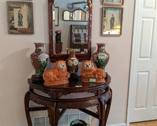 Antique Asian demilune table, pair of very good Asian cloisonne 15" tall vases, smaller Asian cloisonne 10" tall vase, vintage pair of porcelain lions, by Sadler, Bursalem, England, vintage Asian Chinese red beveled glass wall mirror, pair of vintage Asian prints in mirrored frames, pair of framed, vintage Asian 3-D pieces and Etruscan glass ewer, on metal stand.