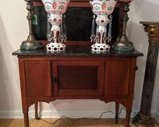 Vintage wood/black marble dry sink, pair of vintage Bohemian glass lusters, vintage pair of  brass/marble table lamps, w/frosted rose glass shades and vintage wood/marble columnar pedestal. 