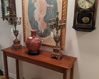 Simple/elegant wooden console table, brass censer (0n floor) pair of antique French 5-light brass/marble candelabras, good oxblood porcelain Asian vase on wooden stand, pair of vintage wall clocks and nicely framed/matted print of "Flora" fresco Roman goddess of flowers. 