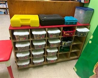 Wooden Lincoln logs and accessories in all buckets with a white lid. Army men and accessories in other bins. Original Pacman Knex  games. Never used. Lego table on the left hand side and a Train table board that fits on top of train tables. 