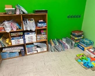 Lots of unopened, brand new board games still in packaging. Hungry Hungry Hippos. Lots of board games. Playing cards.