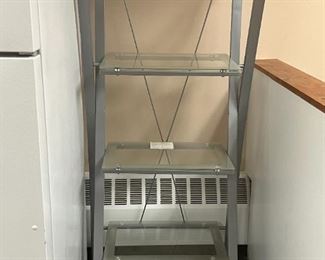 Glass desk shelf. 4 shelves. each shelf is glass.