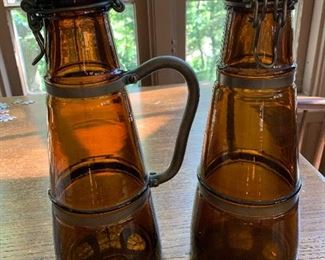 Pair of brown glass beer steins with porcelain lids