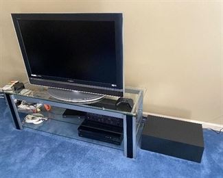 Media stand and tv -Sony 40” 2005 tv, Yamaha receiver RX-500U, Yamaha compact disc player CDC-505, Bose subwoofer and two speakers