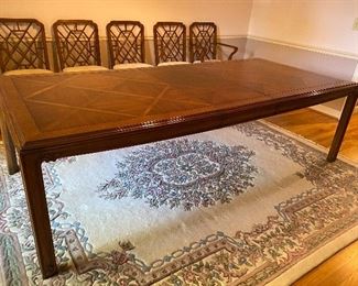 Large dining table shown with one leaf in.