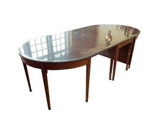 $9000 - Chippendale Marlborough Style Drop Leaf Table CD131-11 Description: Versatile, Chippendale mahogany drop leaf table with Marlborough style legs that opens up to seat four, seating up to eight with two D ends. Table has four central fixed legs and two mid-side pull-out legs that support the drop sides. D ends attach with brass attachment clips that join the drop side to the D-ends. Table includes a set of fully fitted pads for the entire table including D ends. When closed can make a good sofa table. The two D ends are great as console or serving tables.
Condition: Good condition with custom glass top
Dimensions: 103 x 48 x 30"H. 24" Drop Leaf
Local pick up Leesburg, VA. Contact us for shipper suggestions.