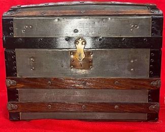 1860's Child’s Camel Back
A beautiful, restored barrel top child’s or sample trunk. This truly shows how they built the samples to the same perfection as the larger ones. This has very nice hardware on the outside with a lock having a patent date of March & Sept 1863. It even has its original leather handles. The inside has been beautifully repapered with a tray. Great piece for a showroom or young daughter or granddaughter.

*Please note we can ship this item although it is marked pickup only, just know there will be additional costs.

14L x 9D x 11H