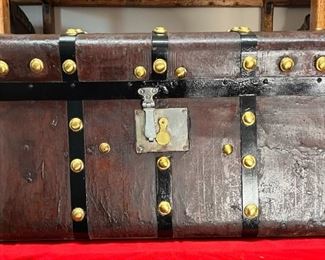 1800's Five Ban Jenny Lind
A leather cover Jenny Lind trunk with the original 5 ban brass buttons on them. Jenny Lind was known as the Swedish Nightingale who came to America with PT Barnum and stole America’s heart in 1850. Most people believe that Jenny Linds were made in and after 1850 but they can be traced back to the 1830s in England. Many things were made using her name such as beds, highchairs, including Jenny Lind Cabins that were insulated with paper. The inside of this trunk was never restored.

*Please note we can ship this item although it is marked pickup only, just know there will be additional costs.

28L x 18D x 16H