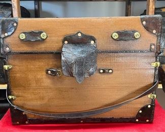 English Wardrobe Trunk
The most I could find on this trunk is that it is from England. It could be a small version of an American Wardrobe trunk. It is canvas covered and has leather corners and edging with brass rivets and stitching. A large leather Lock cover and brass lock and handle caps. It has three different size drawers that slide open with leather handles and brass handle clips. A real find for an Englishman.  

*Please note we can ship this item although it is marked pickup only, just know there will be additional costs.

28L x 19D x 21H