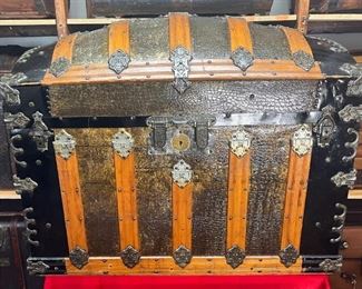 Martin Maier Camel Back
A rare find especially in the south. This is truly our Showroom piece. All original…We chose not to restore this in any way because of its original shape. Martin Maier established his trunk business in 1865 at the age of 25 in Detroit Mich. This was 2 years after joining the Union Army in St Louis and participating in the march to the Sea from Atlanta. Martin Maier was known for making much of his own MM hardware just as you will find on this trunk. Both leather handles have 68 stamped on them which is unusual, but possibly a patent date of 1868. It has a double lock patent Oct. 1871 is quite ornate. It also has some Charles Taylor #2 latches and hardware as well. The inside is equally pristine. All original lithographs with two hat boxes and center tray. 

*Please note we can ship this item although it is marked pickup only, just know there will be additional costs.

37L x 22D x 30H