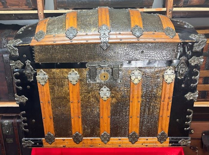 Martin Maier Camel Back
A rare find especially in the south. This is truly our Showroom piece. All original…We chose not to restore this in any way because of its original shape. Martin Maier established his trunk business in 1865 at the age of 25 in Detroit Mich. This was 2 years after joining the Union Army in St Louis and participating in the march to the Sea from Atlanta. Martin Maier was known for making much of his own MM hardware just as you will find on this trunk. Both leather handles have 68 stamped on them which is unusual, but possibly a patent date of 1868. It has a double lock patent Oct. 1871 is quite ornate. It also has some Charles Taylor #2 latches and hardware as well. The inside is equally pristine. All original lithographs with two hat boxes and center tray. 

*Please note we can ship this item although it is marked pickup only, just know there will be additional costs.

37L x 22D x 30H