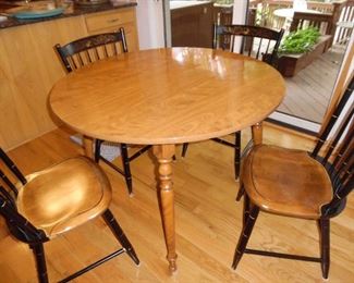 Perfect round table with matching chairs, excellent for a game room, den, or kitchen