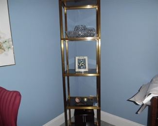 This brass and glass display piece is perfect for displaying items, or can be used in a bathroom for holding towels or in the kitchen to hold spices