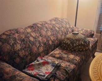 Sofa with wooden legs (no skirt) Tiffany style floor lamp (shade is on the sofa)