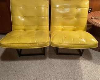 Pair of mid-century modern yellow tufted Naugahyde chairs. Also a matching black one.