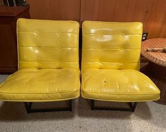 Pair of mid-century modern yellow tufted Naugahyde chairs. Also a matching black one.