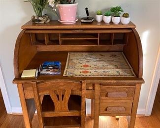 Antique child's roll-top desk and matching chair.