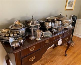 Buffet and silverplate serving items.