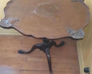 Pie Crust Edge Occasional Table
Beautiful carved occasional Table.  Minal wear, some scratches as noted in pictures.  Appears to be a repair to one foot as noted in pictures.
30" high x 33"diameter 