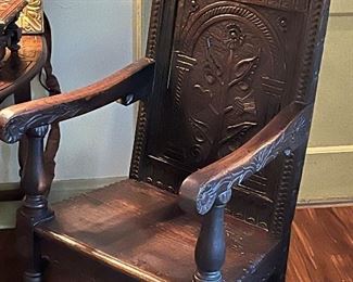 An 18th century Wainscot chair with carved back and  foliate shaped top rail