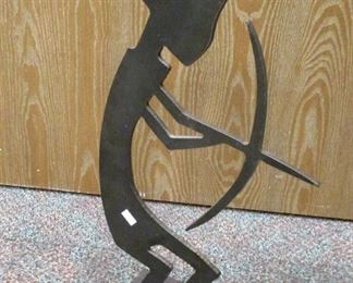 CUT OUR STEEL SCULPTURE OF A FIGURE WITH A BOW. SIGNED 'KS' . 20" TALL