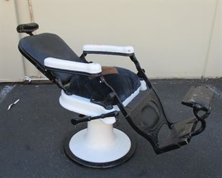 THEO A KOCHS ANTIQUE BARBER CHAIR. Hydraulics pump up and the chair rises, but slowly sinks back down. When it was moved to auction, it was turned on it side and lost much fluid ESTIMATE 295-500 