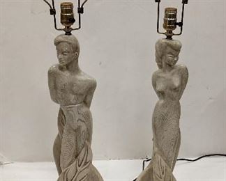 PAIR OF REGLOR OF CALIFORNIA COMPOSITION FIGURAL LAMPS. c 1951. COMPOSITION MATERIAL WITH FAUX GRAIN FINISH. 26.5" TALL TO THE TOP OF THE SOCKET. Condition: no finials, finish nicks on female lamp, crack on the back of the head of male 