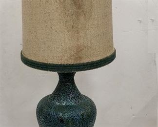 MID-CENTURY POTTERY TABLE LAMP . TURQUOISE/GREEN MOTTLED RELIEF PATTERN, RESEMBLES LAVA . 47" TALL TO THE TIP OF THE SHADE. Condition: shade stained, may need new plug 
