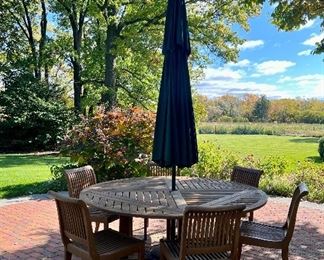 Beautiful Teak Dining Set - this table breaks down to a square table if you don't need the extra seating,  We also have a round umbrella tablecloth custom made for this table in green & white checked!
