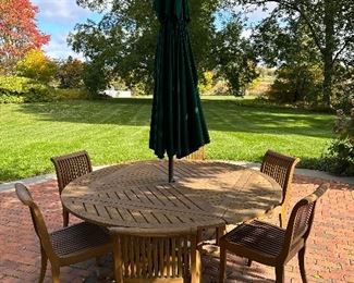 Beautiful Teak Dining Set - this table breaks down to a square table if you don't need the extra seating,  We also have a round umbrella tablecloth custom made for this table in green & white checked!