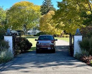 Entrance between two White Pillars and Gate.