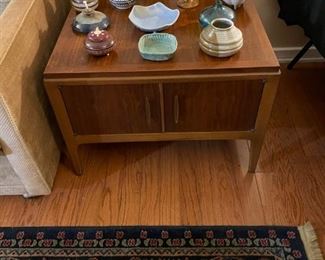 We have a pair of mid-century Walnut side tables